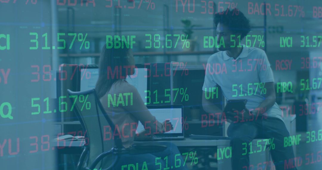 Colleagues Analyzing Financial Data on Tech Devices in Modern Office Environment