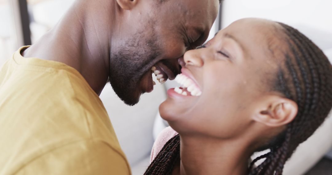 Joyful Couple Embracing at Home During Happy Moments