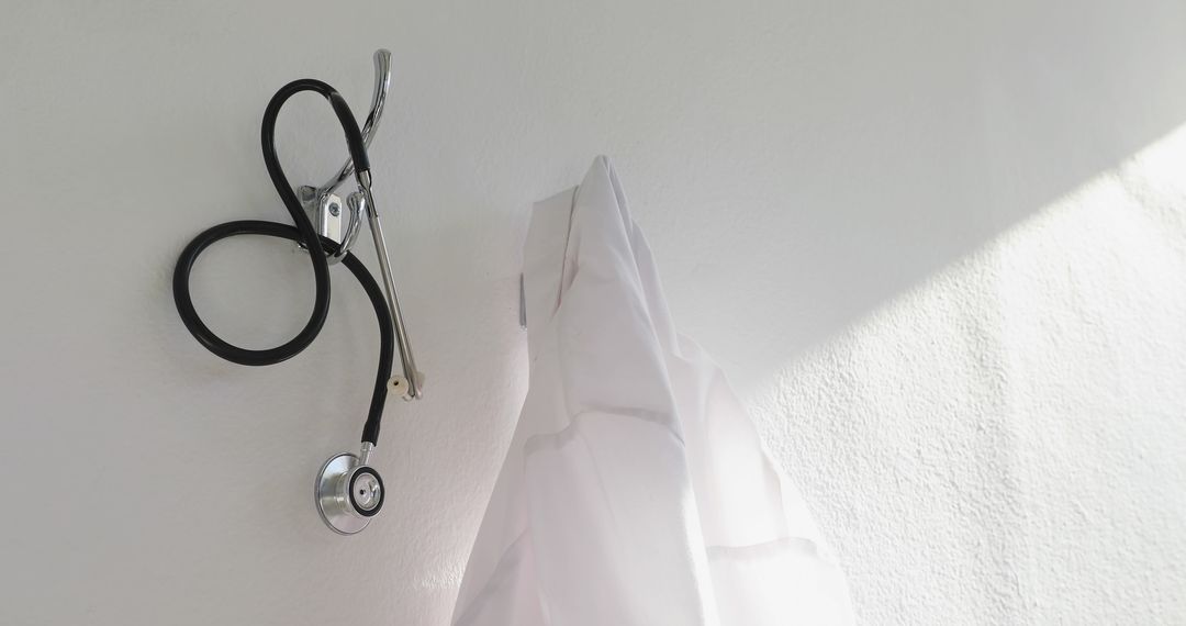 Stethoscope and Medical Coat Hanging on Wall Hook - Free Images, Stock Photos and Pictures on Pikwizard.com