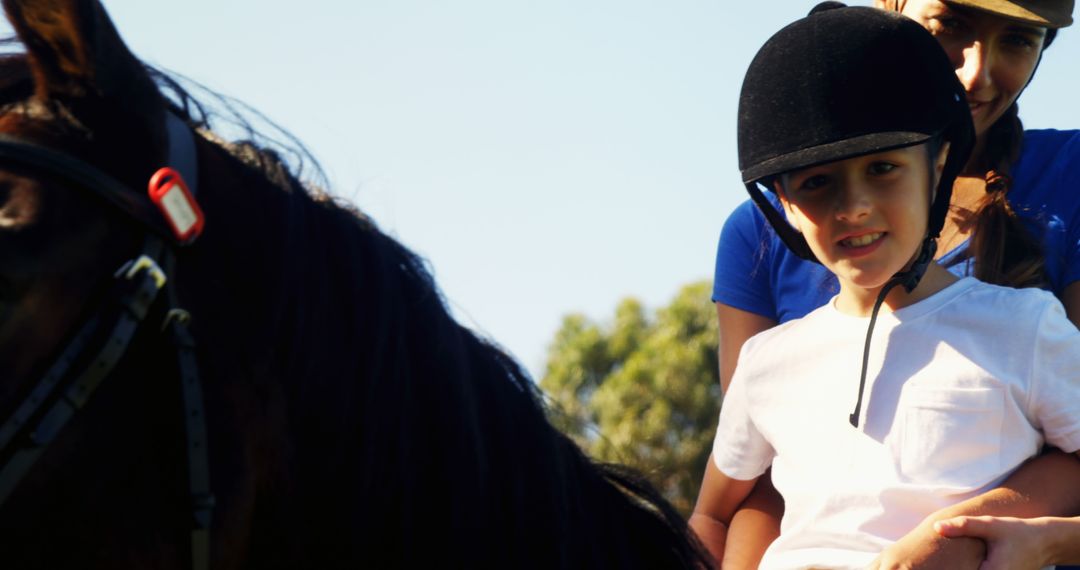 Mother and Child Enjoying Horseback Riding on Sunny Day - Free Images, Stock Photos and Pictures on Pikwizard.com