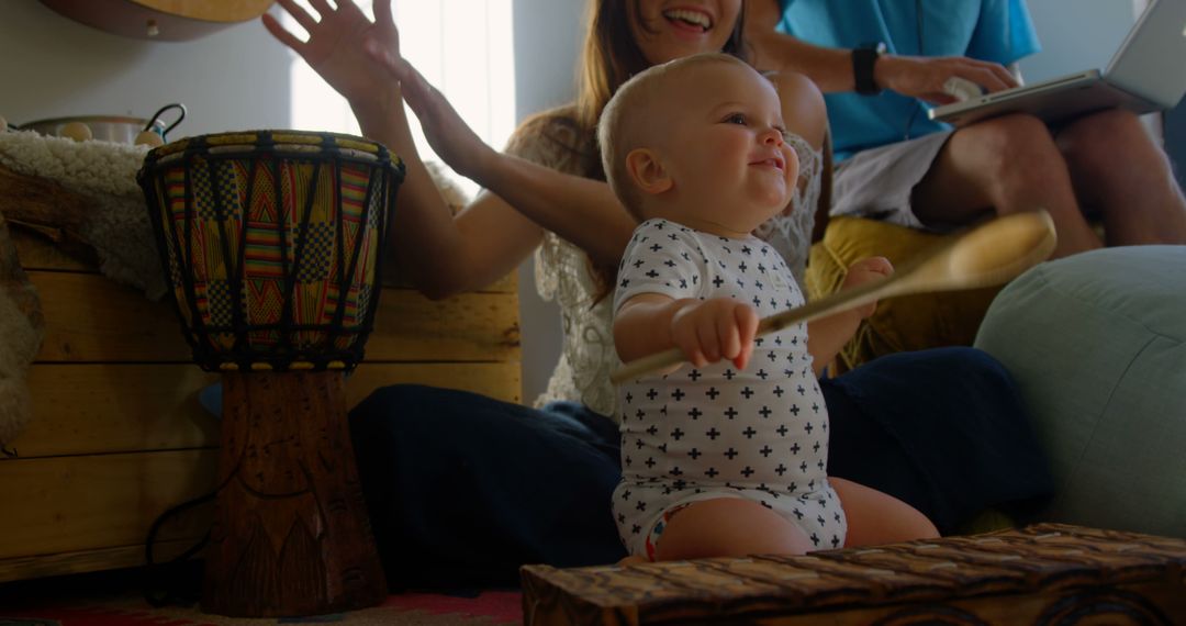 Joyful Baby Playing a Drum with Parents at Home - Free Images, Stock Photos and Pictures on Pikwizard.com