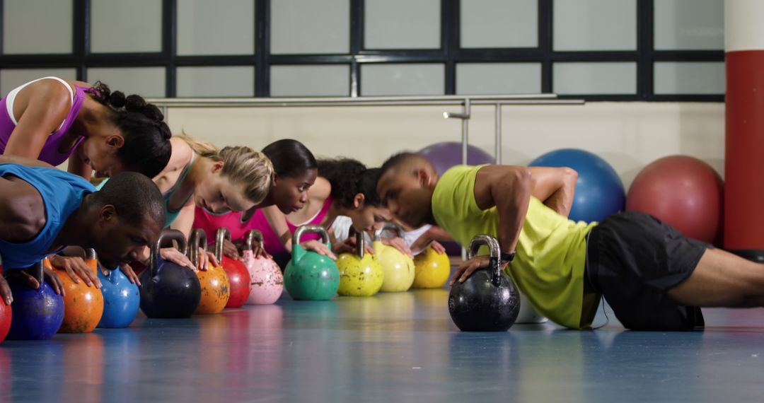 Group Fitness Class Doing Push-Ups on Kettlebells - Free Images, Stock Photos and Pictures on Pikwizard.com