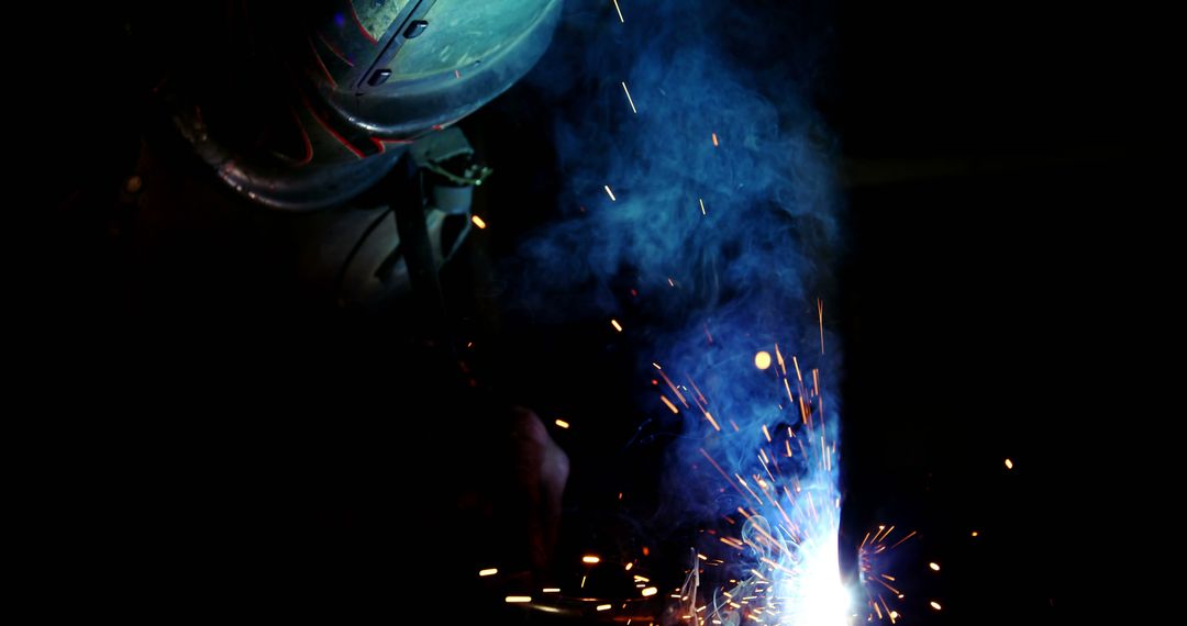 Welder Working with Sparks and Smoke in Dark Workshop - Free Images, Stock Photos and Pictures on Pikwizard.com