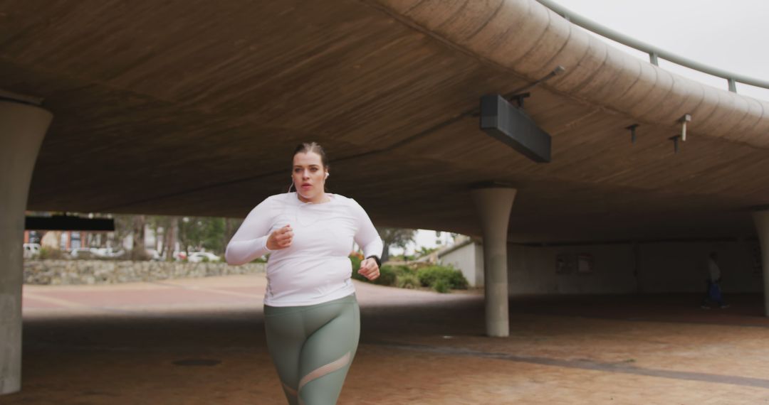 Young Woman Jogging Under Overpass in City Park - Free Images, Stock Photos and Pictures on Pikwizard.com