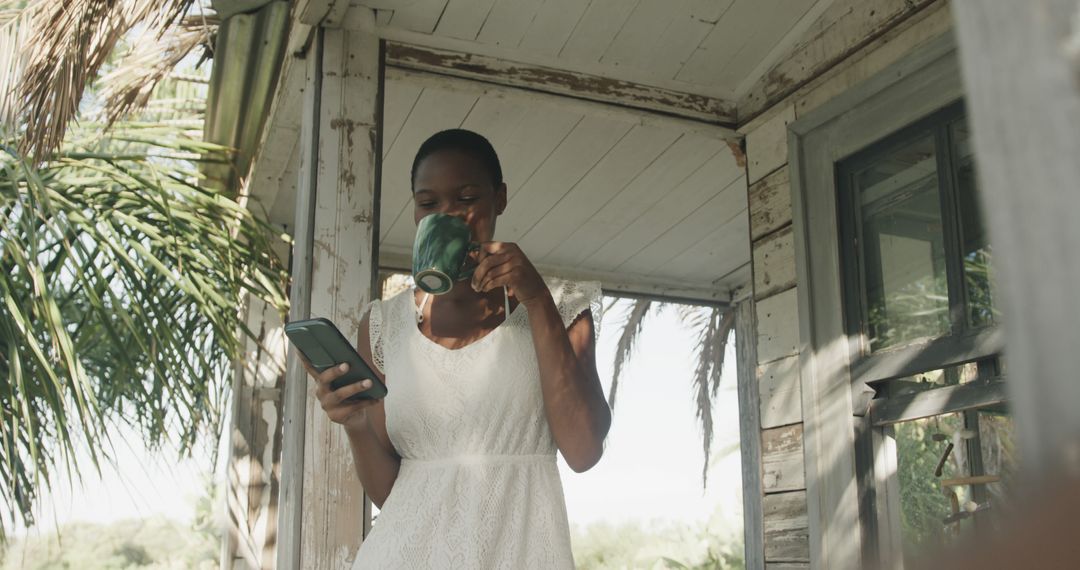 Woman Relaxing With Coffee And Smartphone On Porch - Free Images, Stock Photos and Pictures on Pikwizard.com