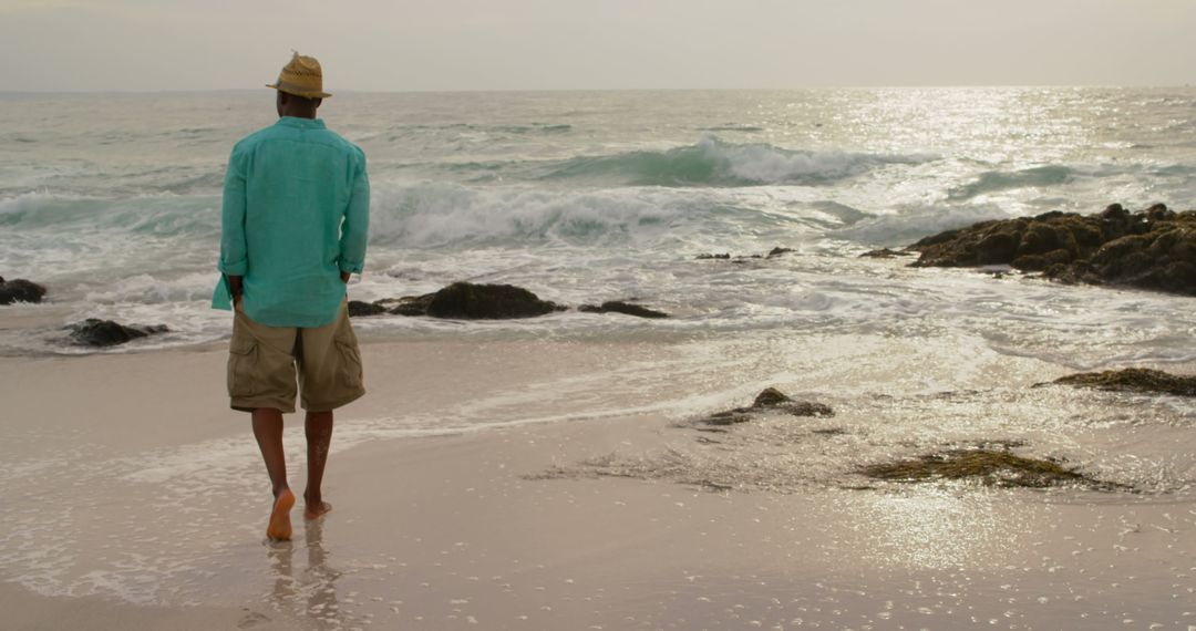 Tranquil Beach Stroll at Sunset by African American Man