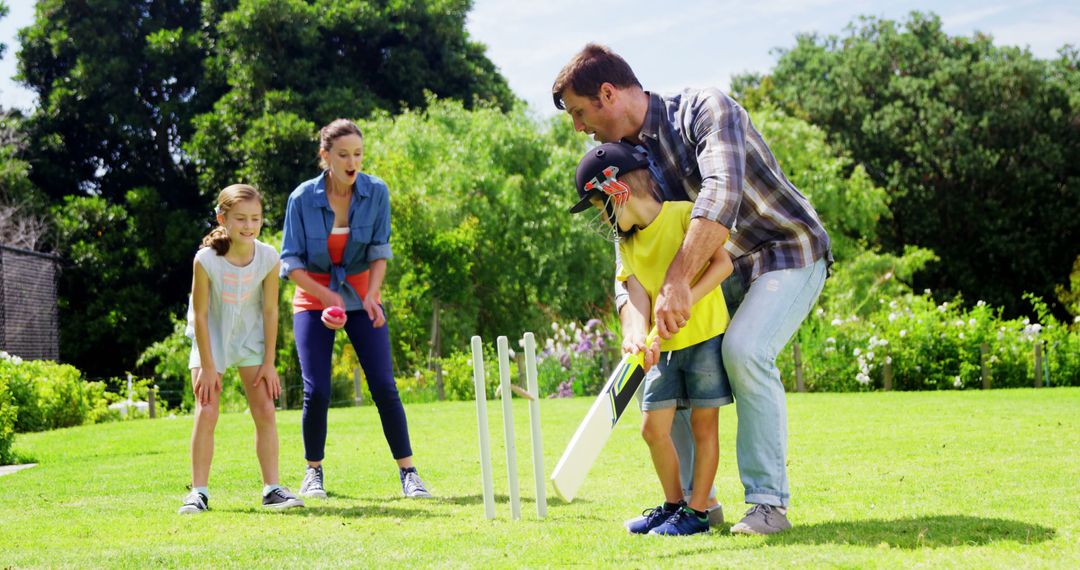 Happy Family Playing Backyard Cricket on a Sunny Day - Free Images, Stock Photos and Pictures on Pikwizard.com