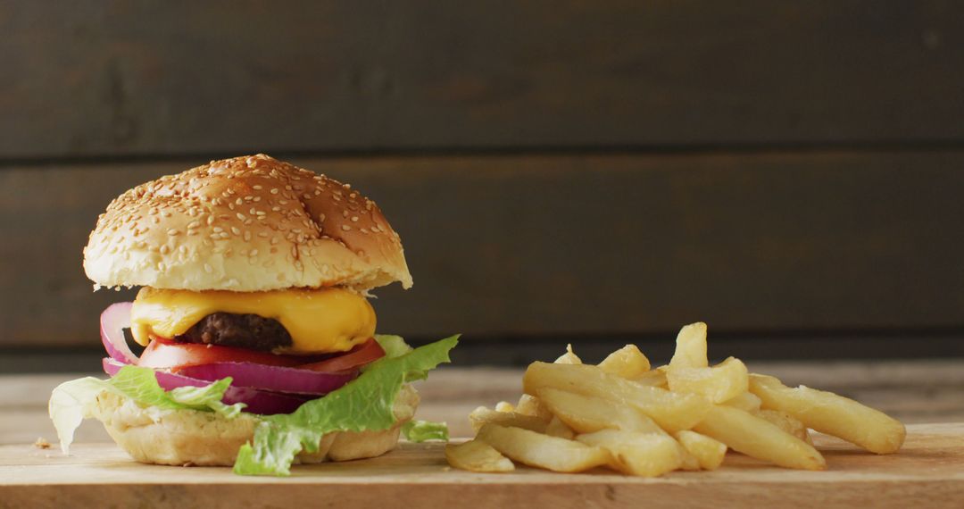 Delicious Cheeseburger and Fries on Wooden Table - Free Images, Stock Photos and Pictures on Pikwizard.com