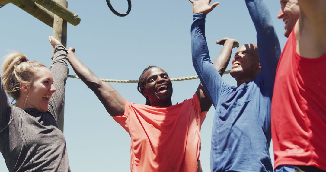 Diverse Group Cheering After Completing Outdoor Obstacle Course