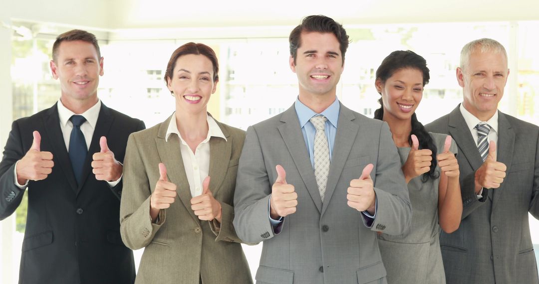 Confident Business Team Giving Thumbs Up in Modern Office - Free Images, Stock Photos and Pictures on Pikwizard.com