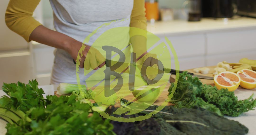 Person Cutting Vegetables with Bio Overlay in Modern Kitchen - Free Images, Stock Photos and Pictures on Pikwizard.com