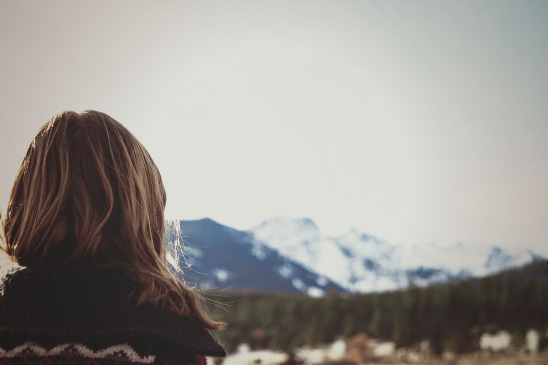 Woman admiring scenic snowy mountains on a bright day - Free Images, Stock Photos and Pictures on Pikwizard.com