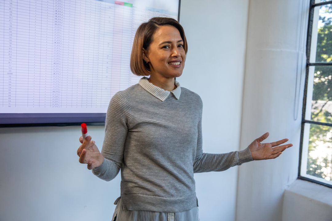 Professional Woman Presenting Data Analysis with Presentation Screen