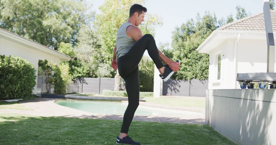 Man Exercising Outdoors Performing High Knees in Backyard - Free Images, Stock Photos and Pictures on Pikwizard.com