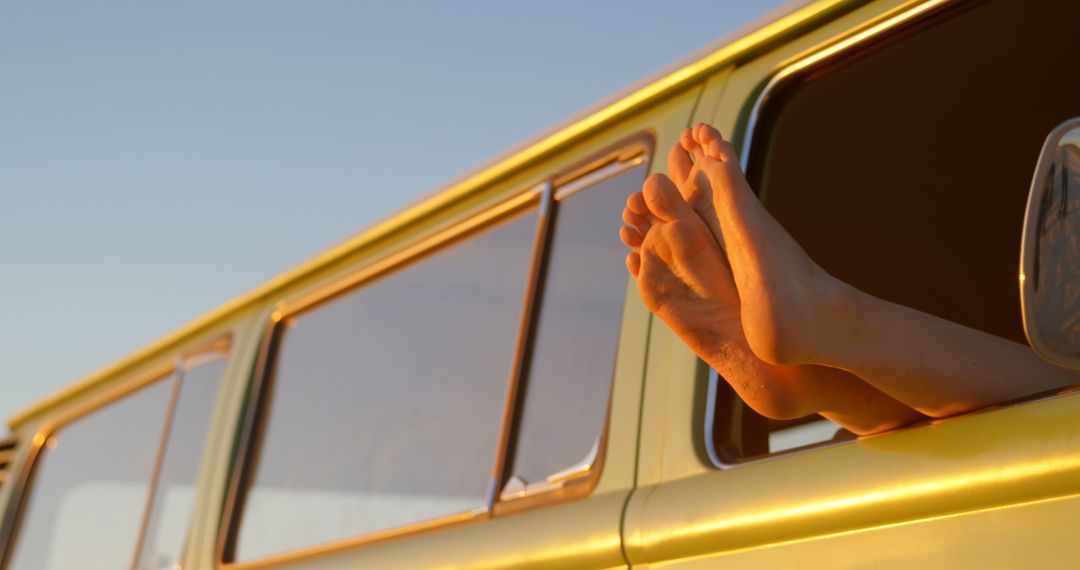 Relaxed Road Trip Feet Lingering out Van Window at Sunset - Free Images, Stock Photos and Pictures on Pikwizard.com