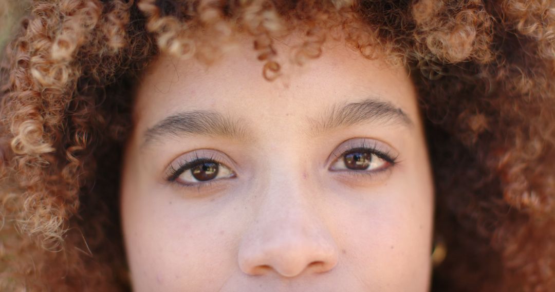 Close-up on Face with Brown Curly Hair and Bright Eyes - Free Images, Stock Photos and Pictures on Pikwizard.com