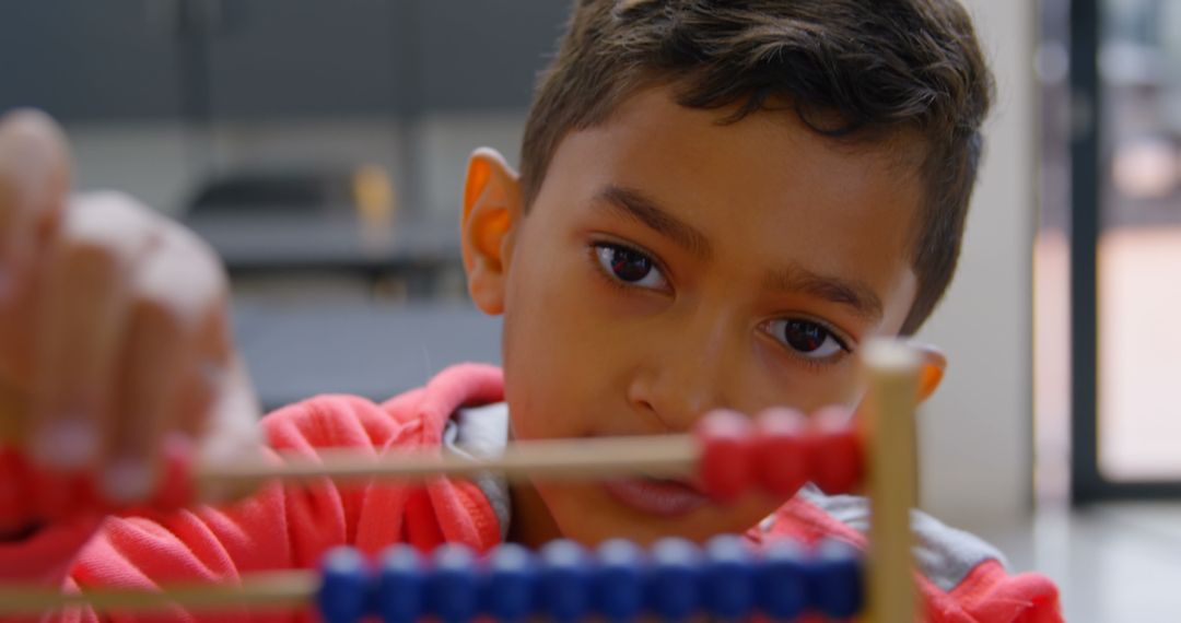 Young Boy Concentration Abacus Learning Concept