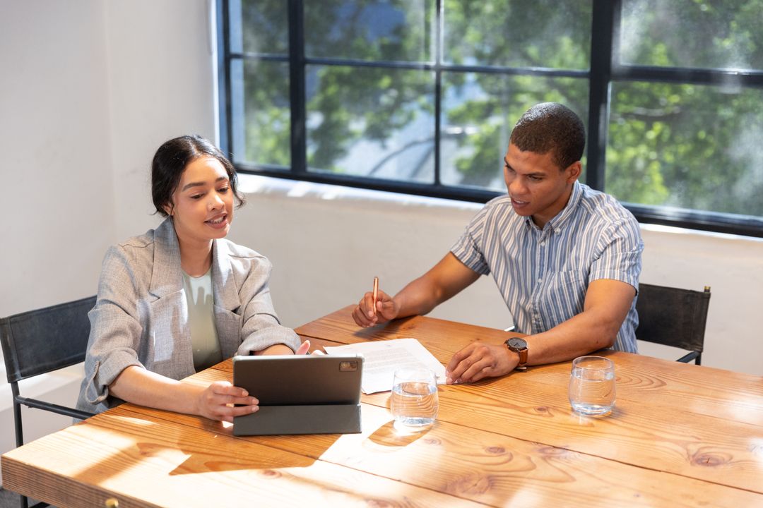 Professional Colleagues Collaborating at Conference Table