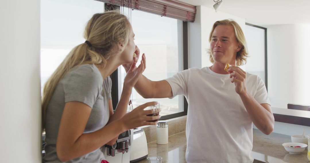 Playful Couple Enjoying Breakfast Together in Kitchen