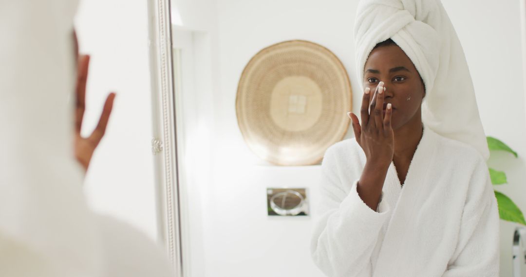 Woman Applying Moisturizer During Skincare Routine in Bathroom - Free Images, Stock Photos and Pictures on Pikwizard.com