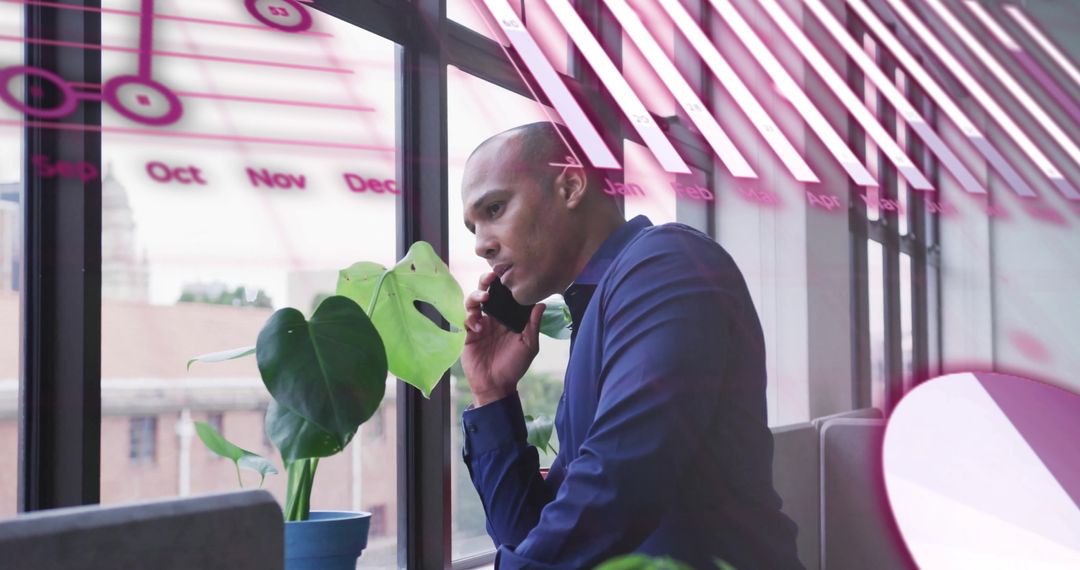 Businessman Analyzing Financial Data by Window in Office
