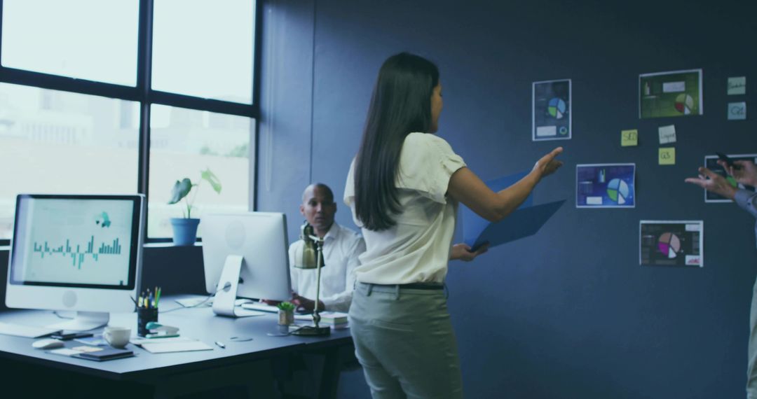 Business Team Analyzing Data in Modern Office with Charts