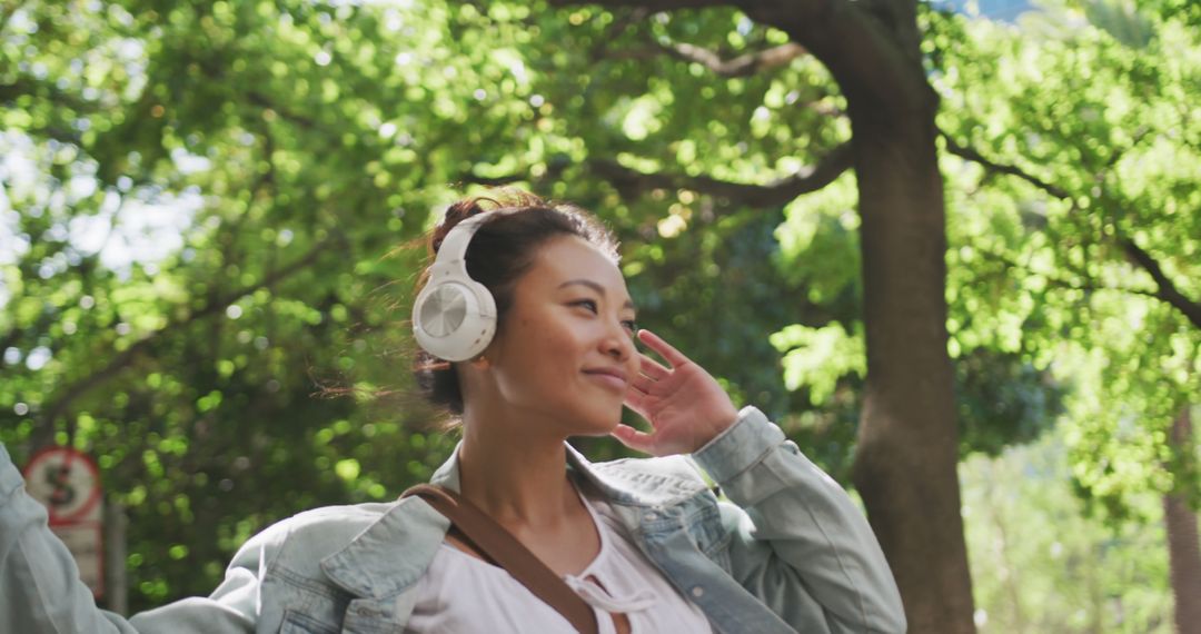 Woman Enjoying Music with Headphones in Park - Free Images, Stock Photos and Pictures on Pikwizard.com