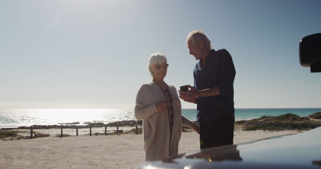 Senior Couple Enjoying Coastal View at Beach - Free Images, Stock Photos and Pictures on Pikwizard.com