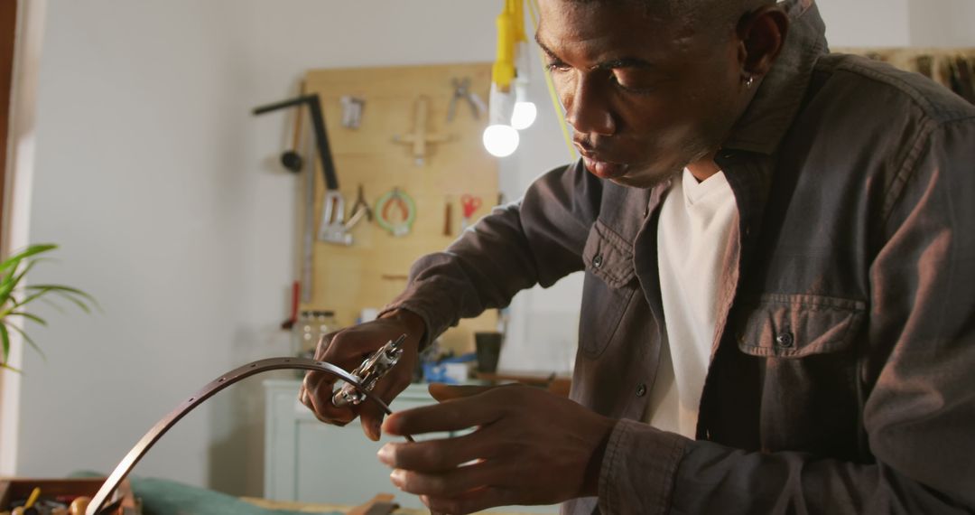 Focused Craftsman Creating Leatherwork Using Precision Tools