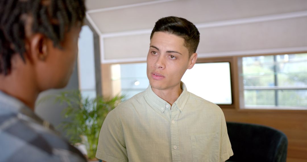 Colleagues Engaging in Work Discussion in Modern Office