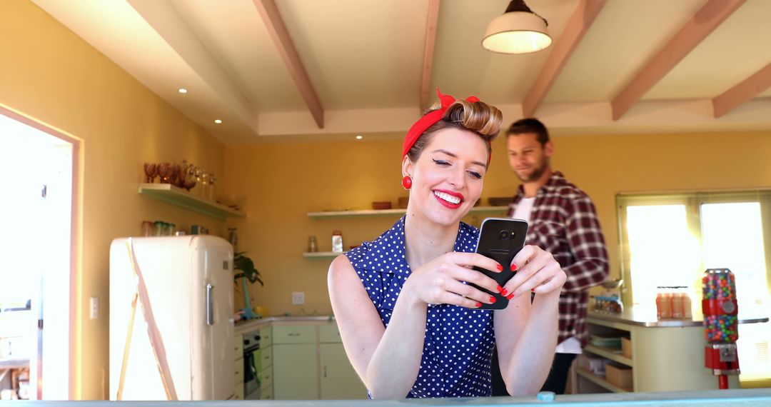 Happy Woman Using Smartphone in Retro Kitchen - Free Images, Stock Photos and Pictures on Pikwizard.com