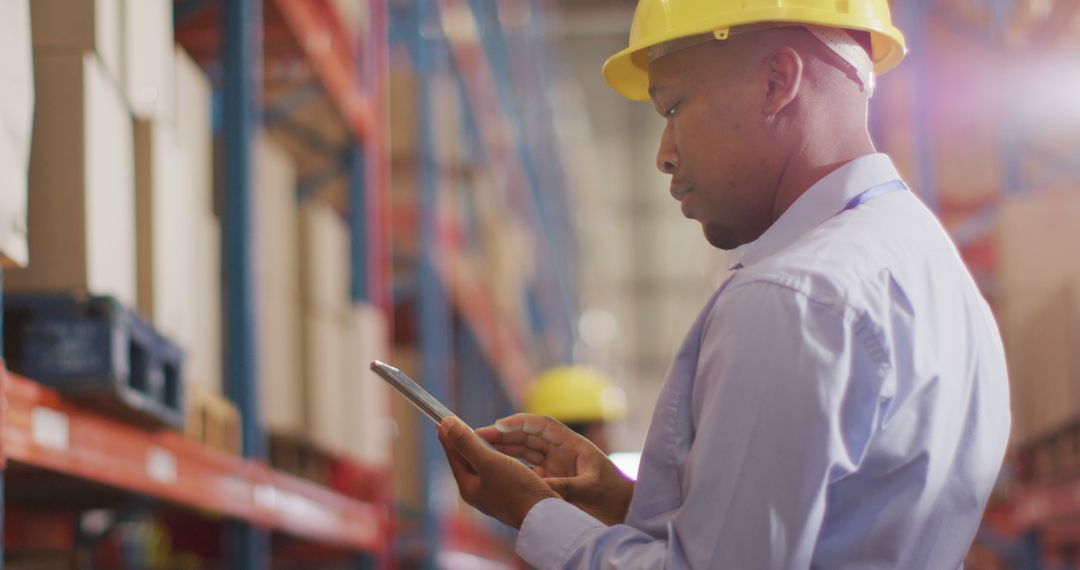 Engineer Using Tablet in Warehouse for Inventory Management - Free Images, Stock Photos and Pictures on Pikwizard.com