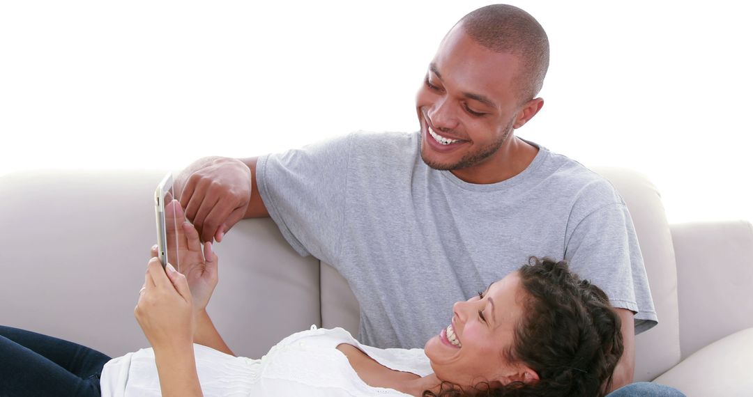 Happy Couple Using Smartphone at Home Smiling