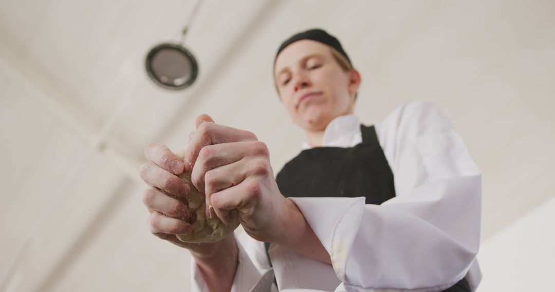 Professional Baker Kneading Dough in Industrial Kitchen - Free Images, Stock Photos and Pictures on Pikwizard.com