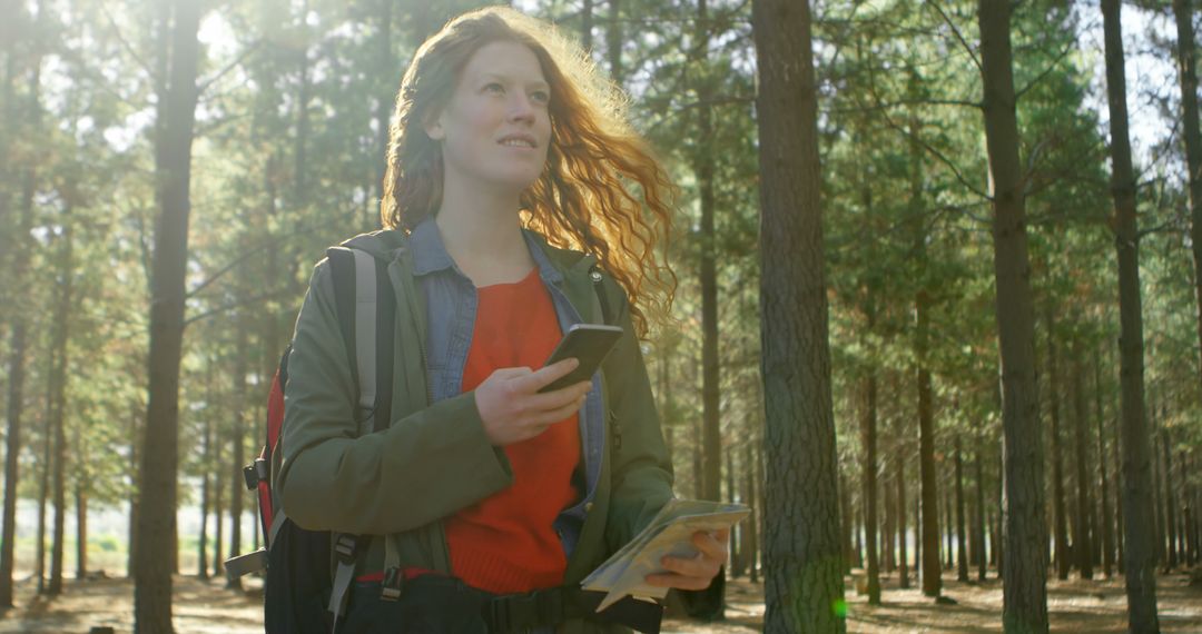 Young Woman Hiking with Smartphone and Map in Forest - Free Images, Stock Photos and Pictures on Pikwizard.com