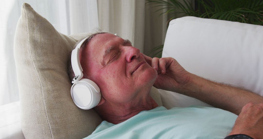 Elderly Man Relaxing with Headphones Listening to Music - Free Images, Stock Photos and Pictures on Pikwizard.com