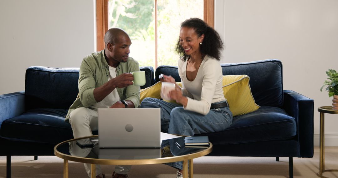 Happy Couple Celebrating Friendship with Coffee on Couch