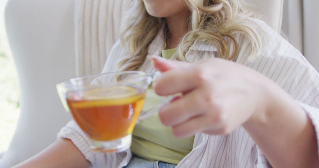 Woman Relaxing with Herbal Tea in Cozy Chair - Free Images, Stock Photos and Pictures on Pikwizard.com