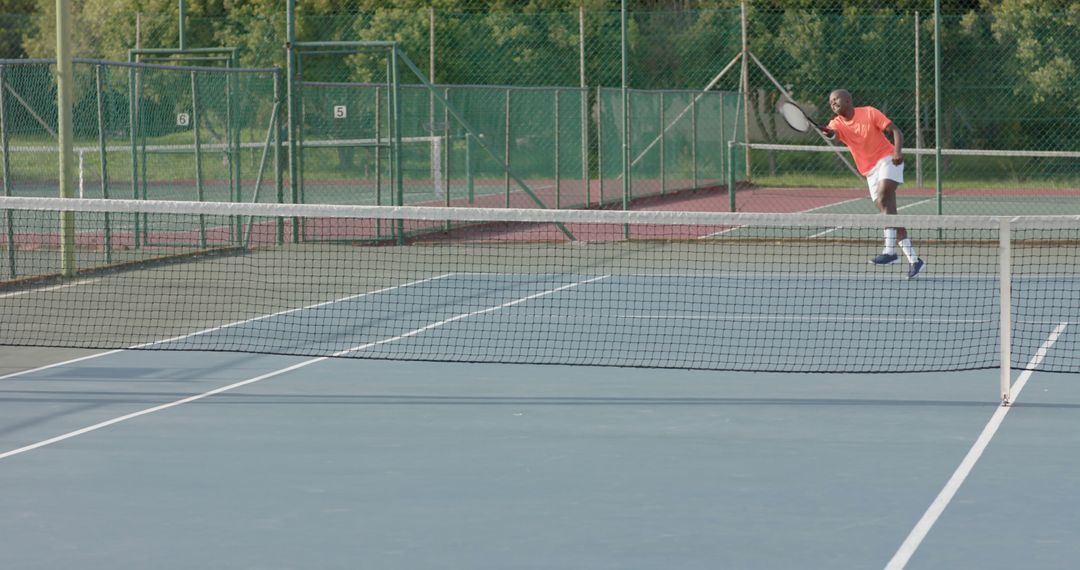 Man playing tennis on outdoor court hitting serve - Free Images, Stock Photos and Pictures on Pikwizard.com