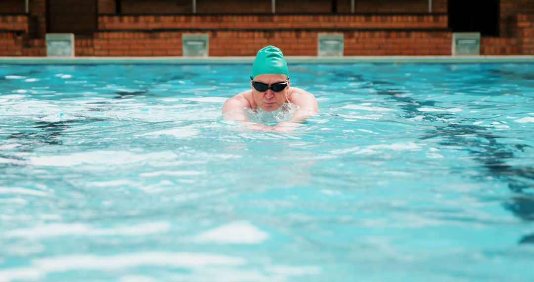 Professional Swimmer Practicing Breaststroke in Indoor Pool - Free Images, Stock Photos and Pictures on Pikwizard.com