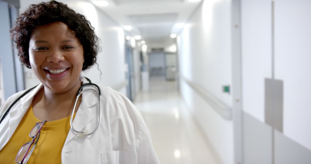 Smiling Nurse in Hospital Corridor with Stethoscope - Free Images, Stock Photos and Pictures on Pikwizard.com