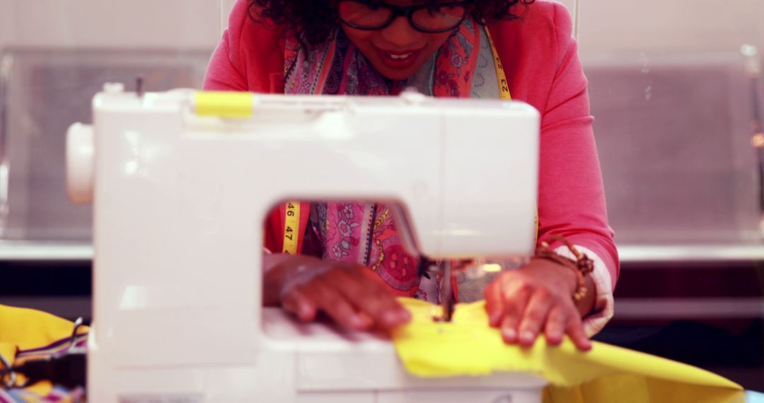 Woman Sewing Cloth with Machine Focusing on Task Creativity - Free Images, Stock Photos and Pictures on Pikwizard.com