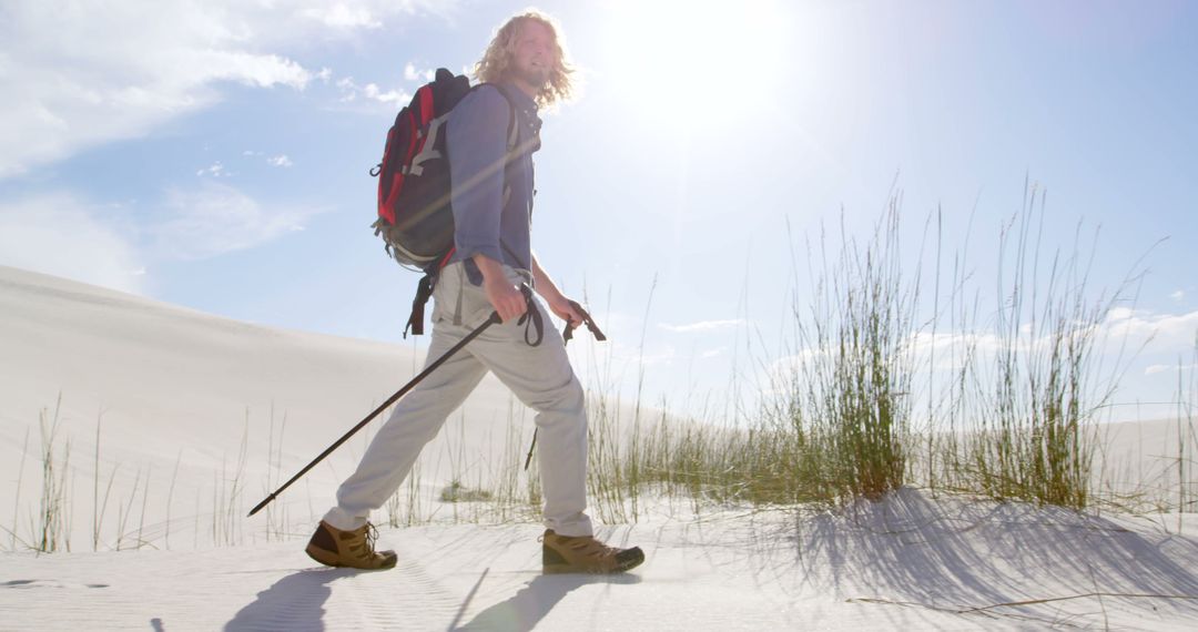Man Hiking on Sandy Desert in Bright Sunlight - Free Images, Stock Photos and Pictures on Pikwizard.com