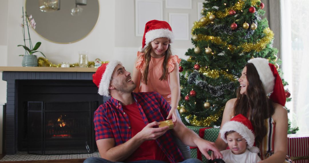Joyful Family Opening Christmas Gifts by Tree