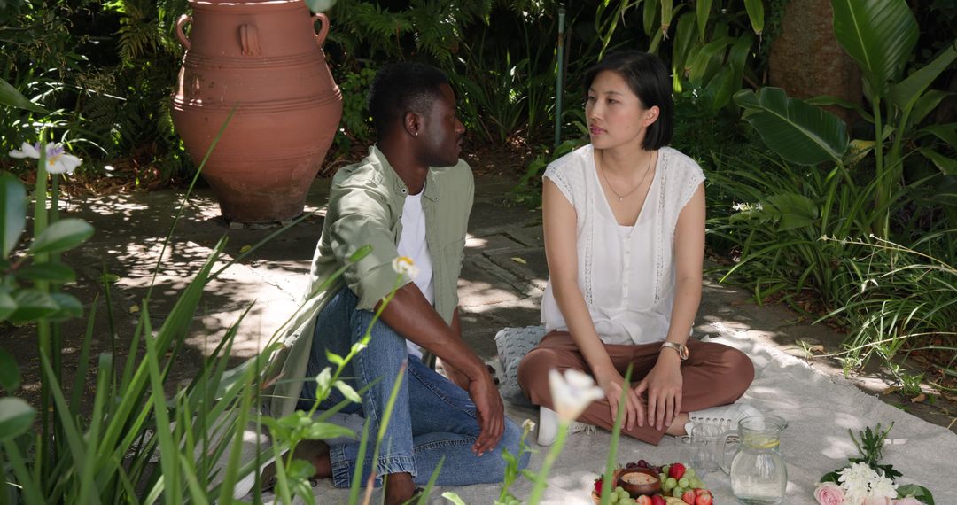 Diverse Friends Enjoying Garden Picnic in Tranquil Setting