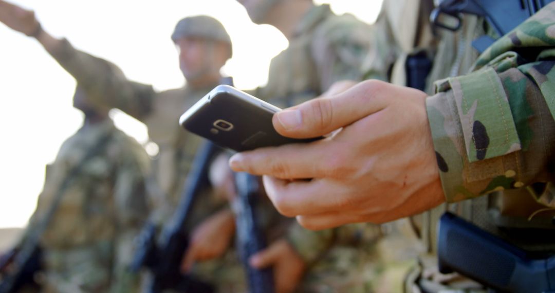 Military Soldier Using Mobile Phone During Training Exercise