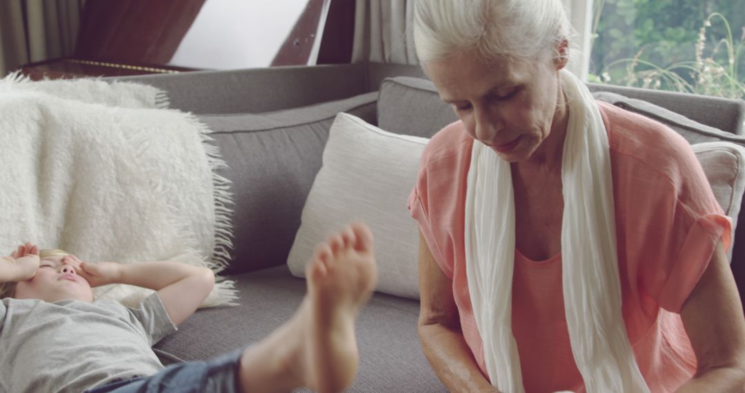 Grandmother Looking After Playful Grandson at Home - Free Images, Stock Photos and Pictures on Pikwizard.com