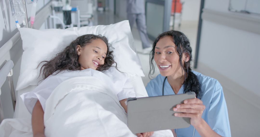 Nurse with Young Patient Smiling while Using Digital Tablet in Hospital Ward - Free Images, Stock Photos and Pictures on Pikwizard.com