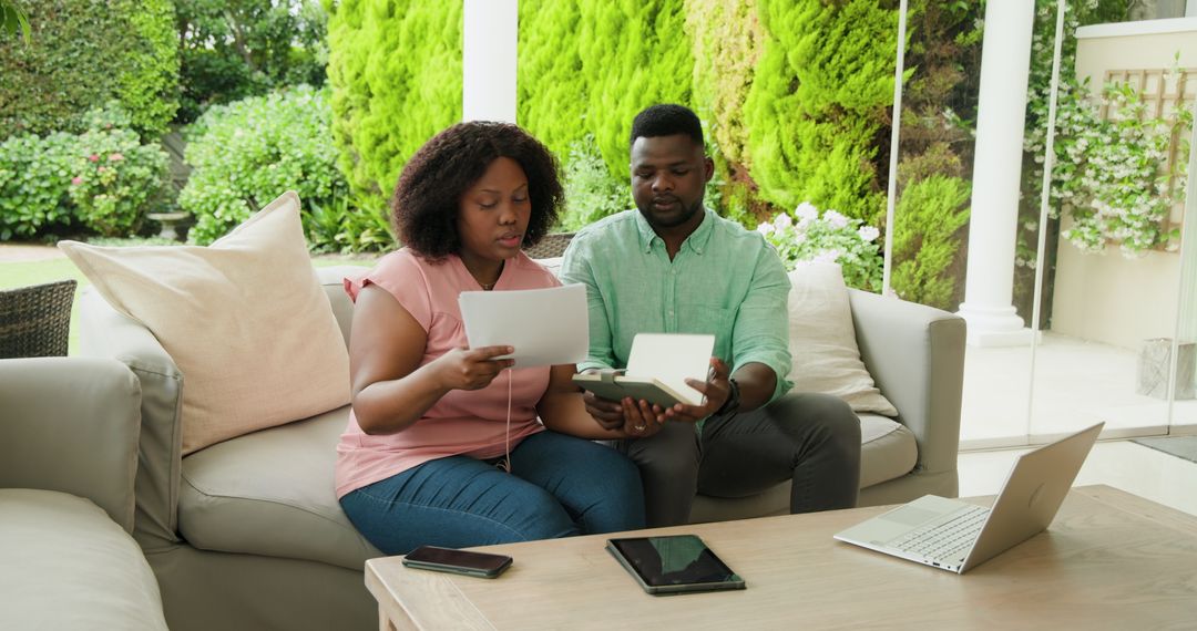 Couple Planning Finances Discussing Documents on Patio