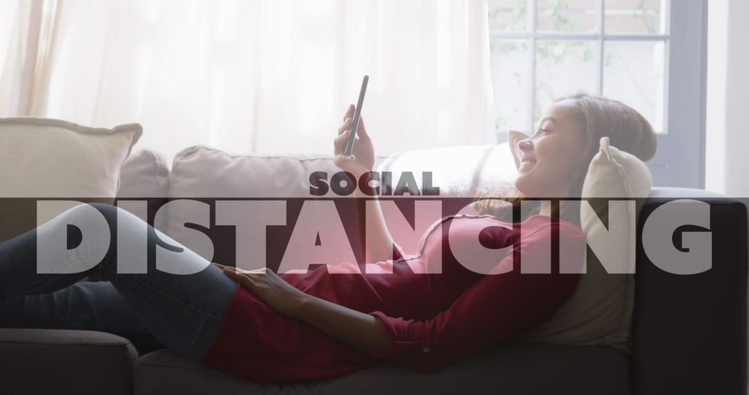 Woman Relaxing at Home on Couch Using Smartphone